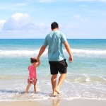 Daughter and Man Living Off Income from Investment Portfolio at Beach