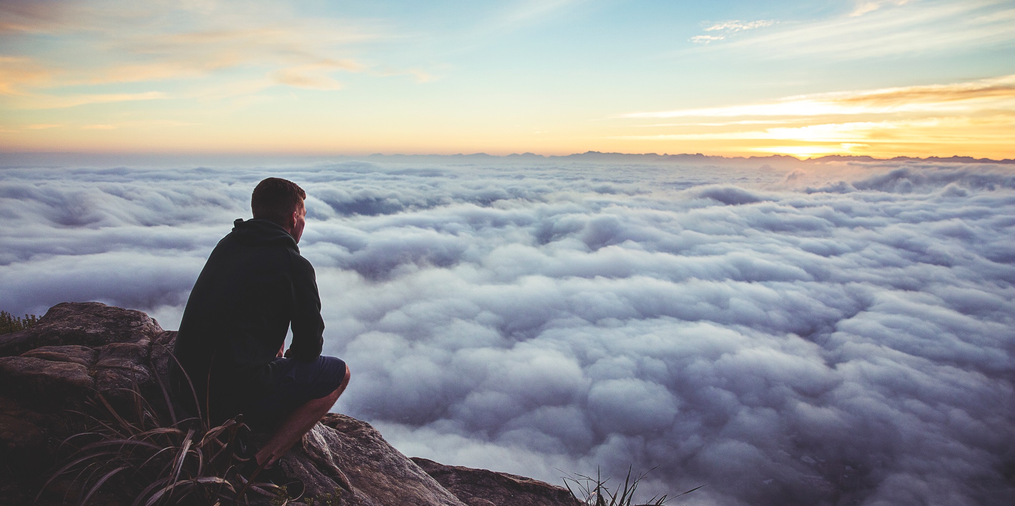 Man on Mountaintop Representing Legacy Portfolio Receiving New Vision from Financial Advisors