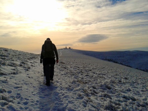 Financial Guidance Services Shown by Man Ascending Mountain